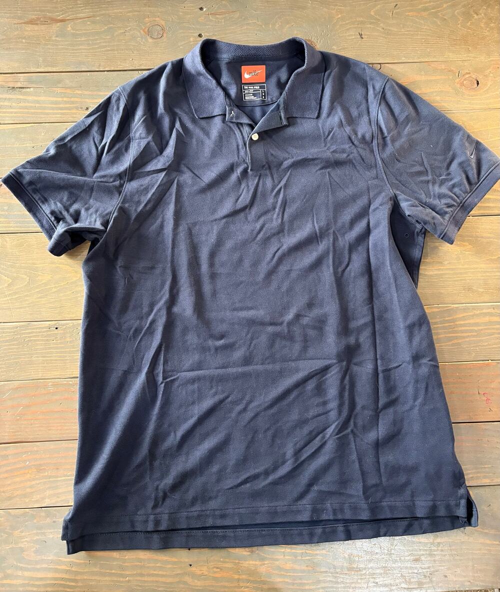 The Nike Polo dri-fit navy blue short sleeve shirt men's size large